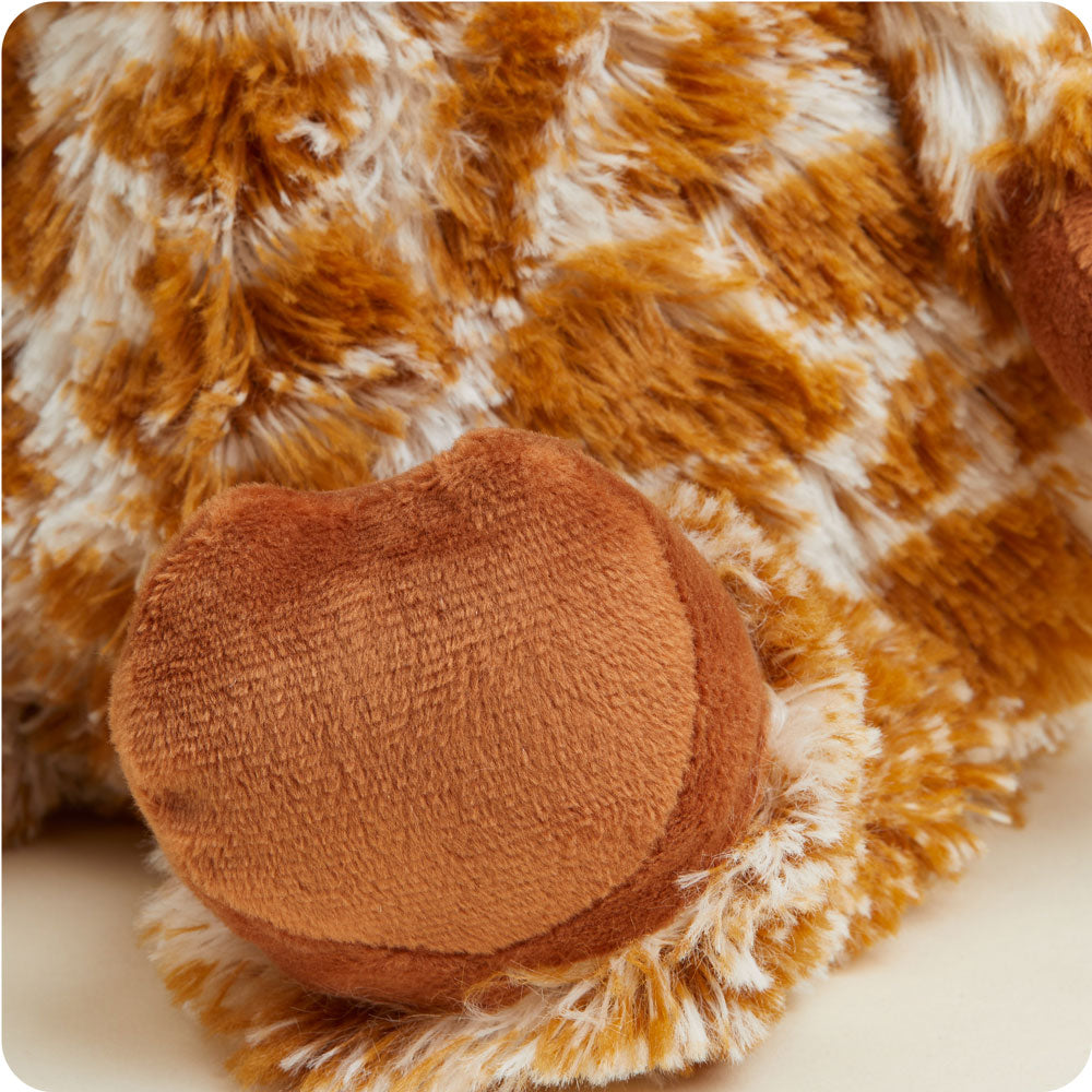Warmies plush heating pad in giraffe print with orange patches and cream base