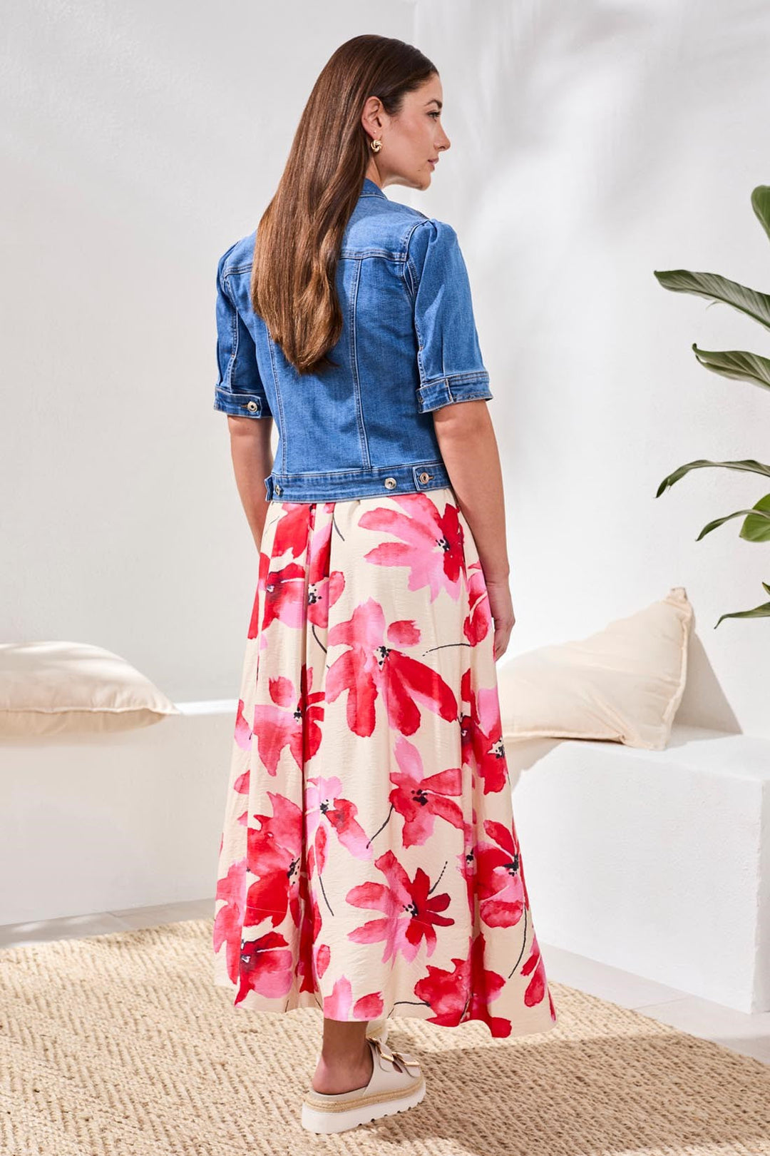 Woman wearing blue denim elbow sleeve jacket with floral maxi skirt