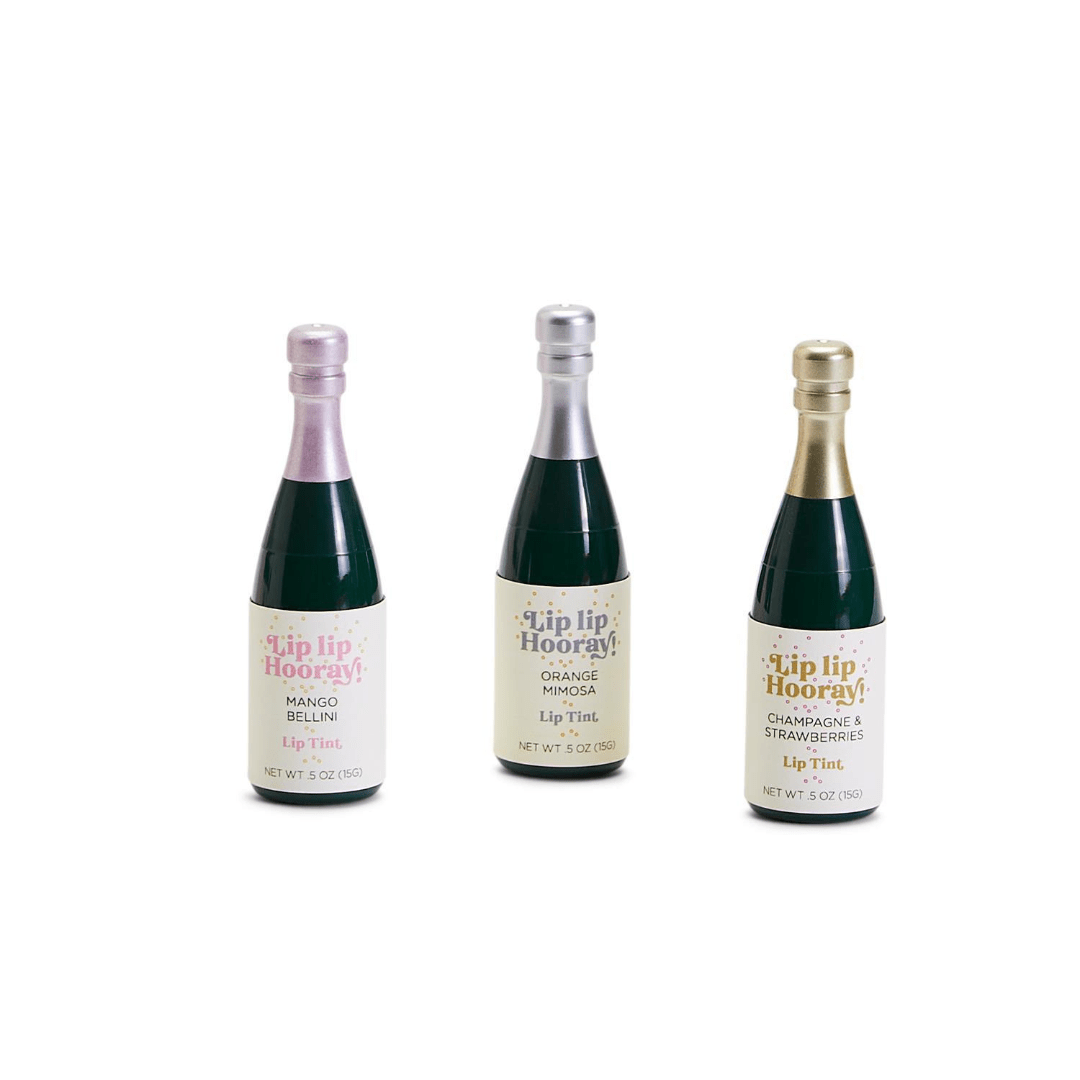 Three champagne bottle shaped lip tints in Mango Bellini, Orange Mimosa, and Champagne Strawberries flavors