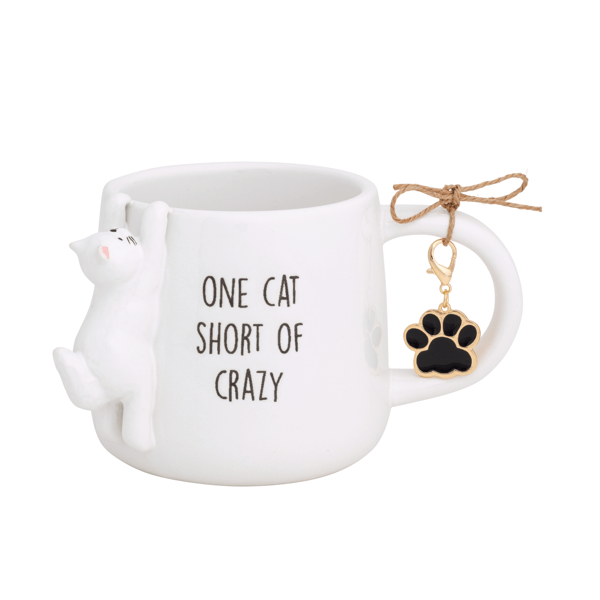 White ceramic mug with cat figure and 'ONE CAT SHORT OF CRAZY' text, paw charm