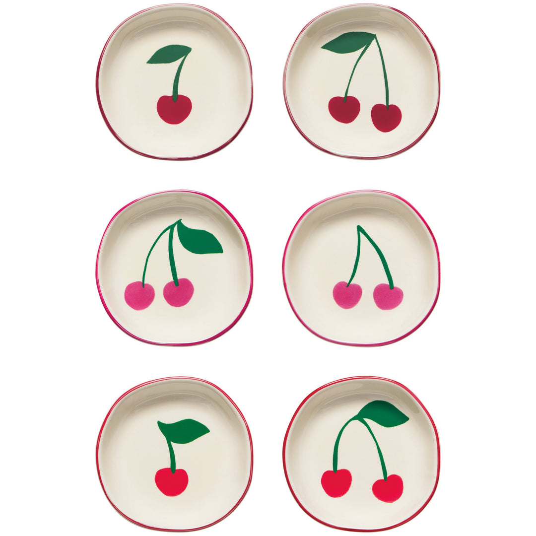 Six cream-colored pinch bowls with red cherry motifs and matching red rim details